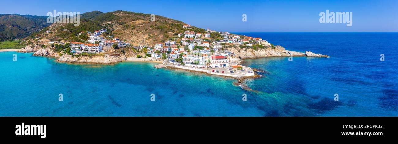 Lovely greek fishing village of Armenistis in a quiet summer morning. Port with local beach in transparent clear water at Ikaria, Greece Stock Photo