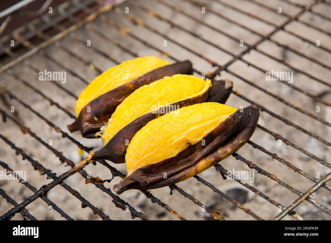 Bananas on a grill at a street food stall in Bangkok Stock Photo Alamy