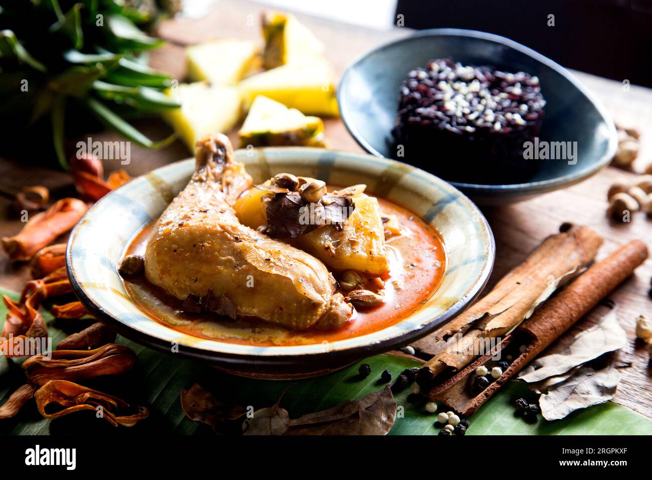 Massaman Curry with chicken and black rice in a restaurant in Chiang Mai in northern Thailand. Stock Photo