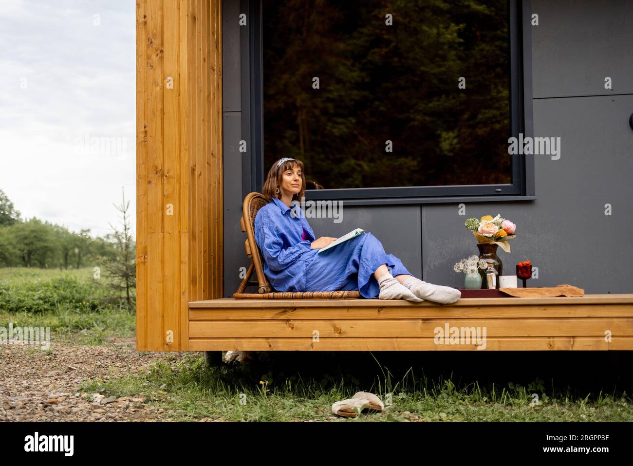 Woman on terrace of house on nature Stock Photo - Alamy
