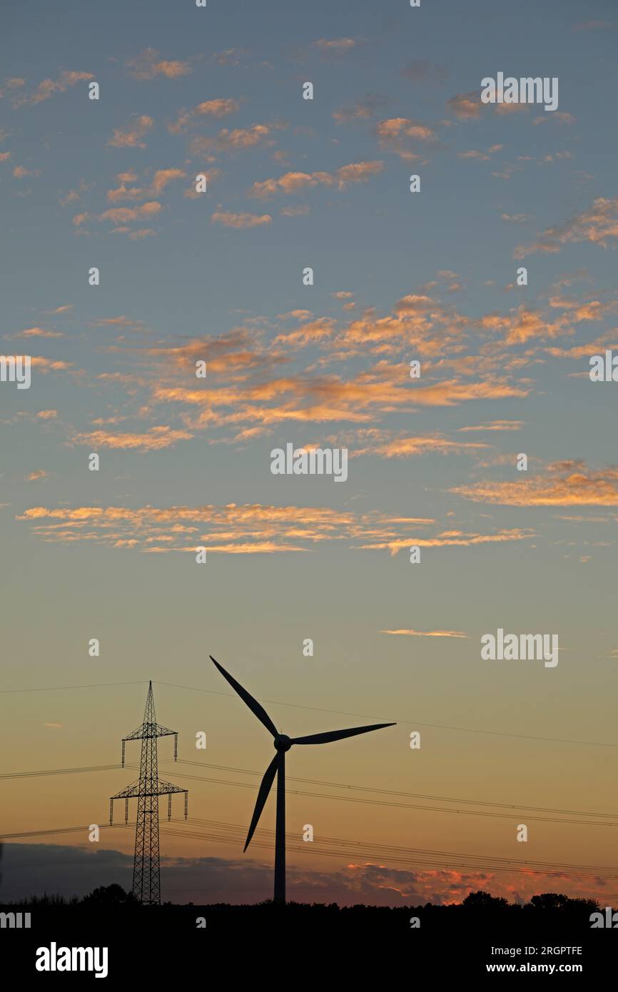 Afterglow, wind power station, pylon, clouds, Melbeck, Ilmenau joint community, Lower Saxony, Germany Stock Photo