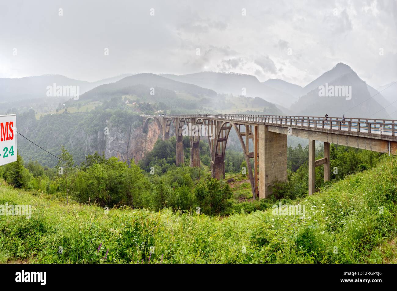 High angle scenic view of Tara river canyon with Durdevica Tara Bridge between the villages Budečevica and Trešnjica in cloudy summer day, Montenegro. Stock Photo