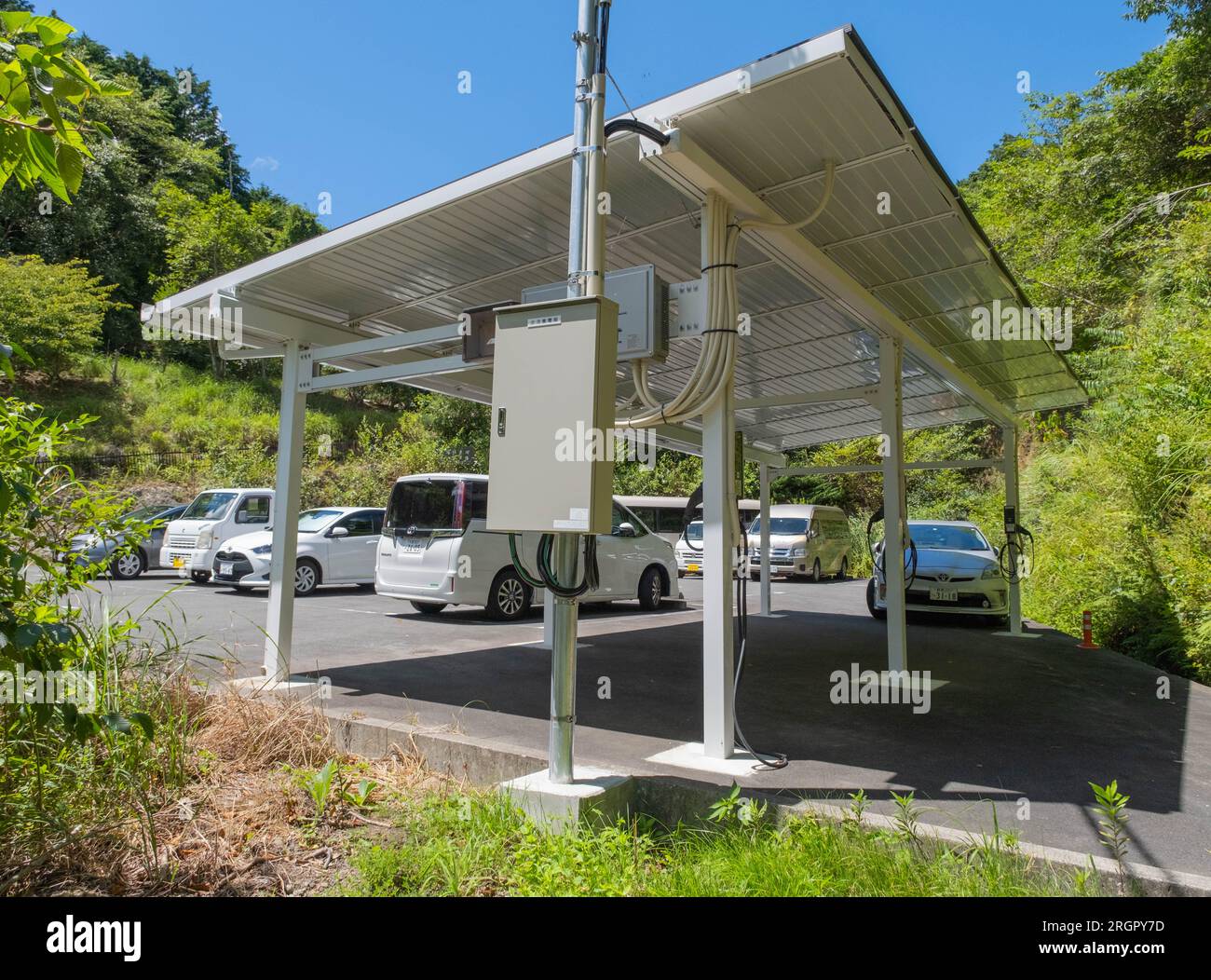 A covered electric vehicle charging station with solar panels on the ...