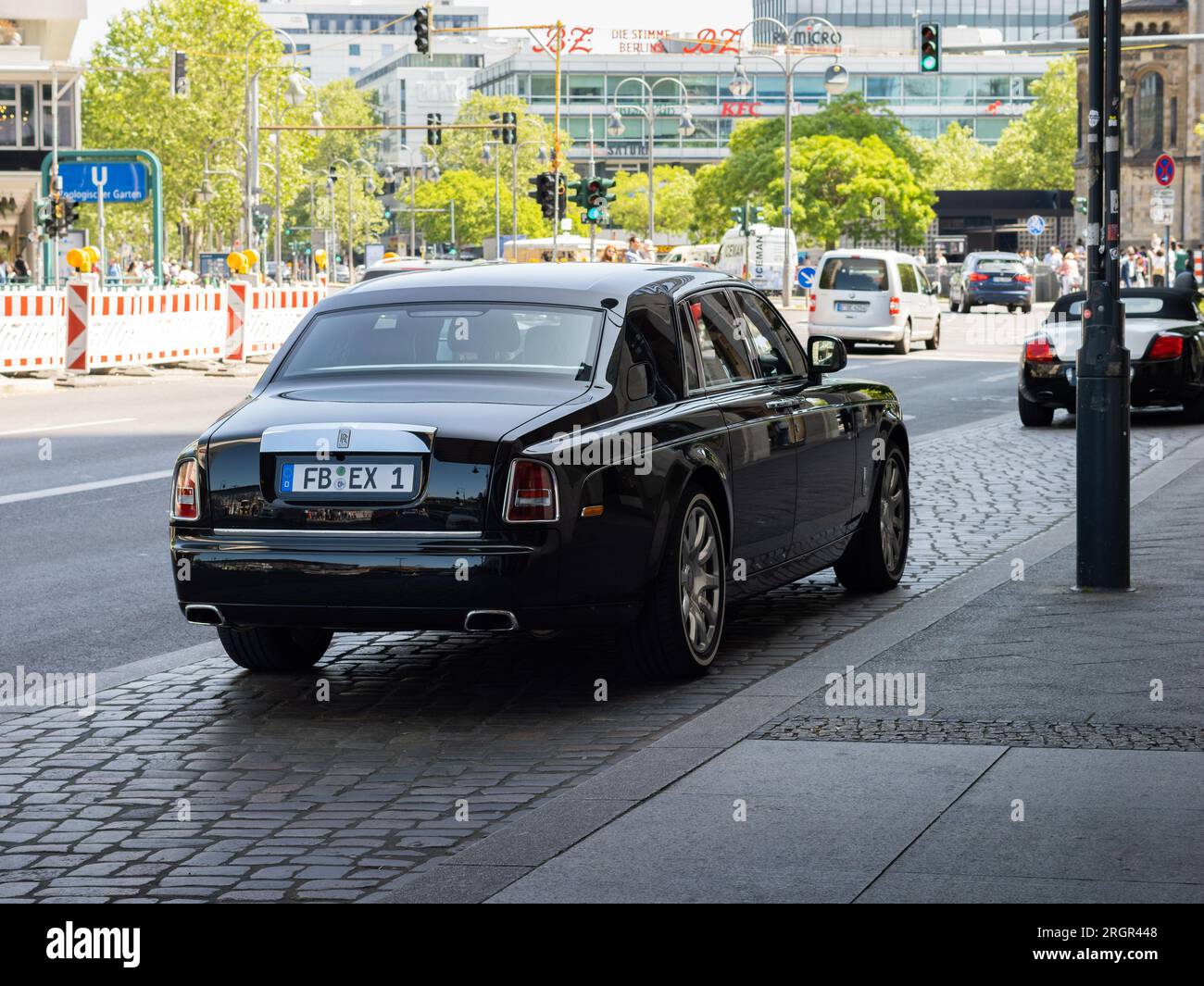 Rear of a Rolls Royce Phantom car. The luxury limousine is parking next to a street in the city. Stock Photo