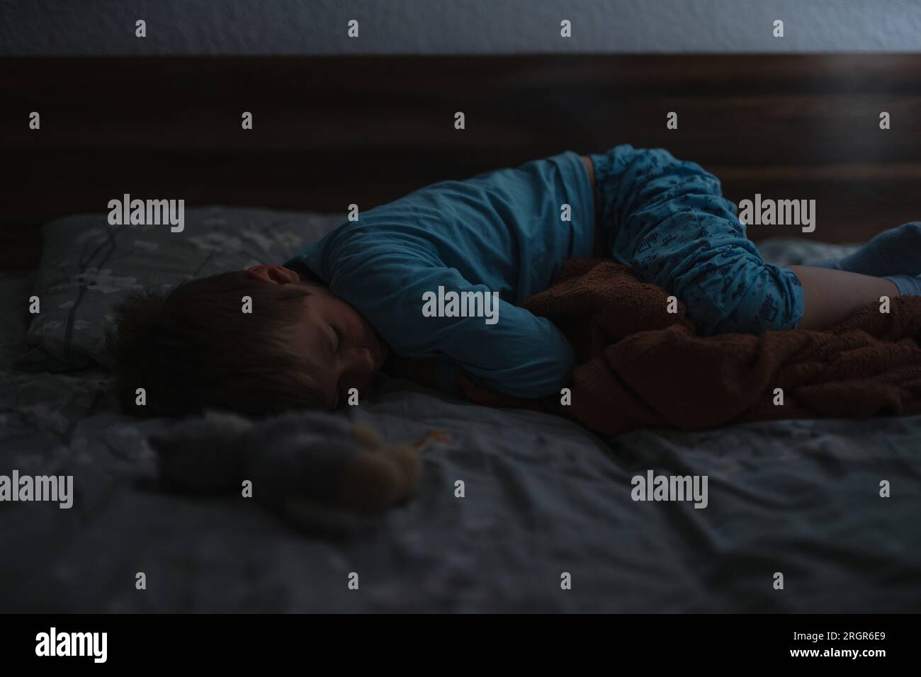 Little boy asleep in his bed early in the morning Stock Photo Alamy