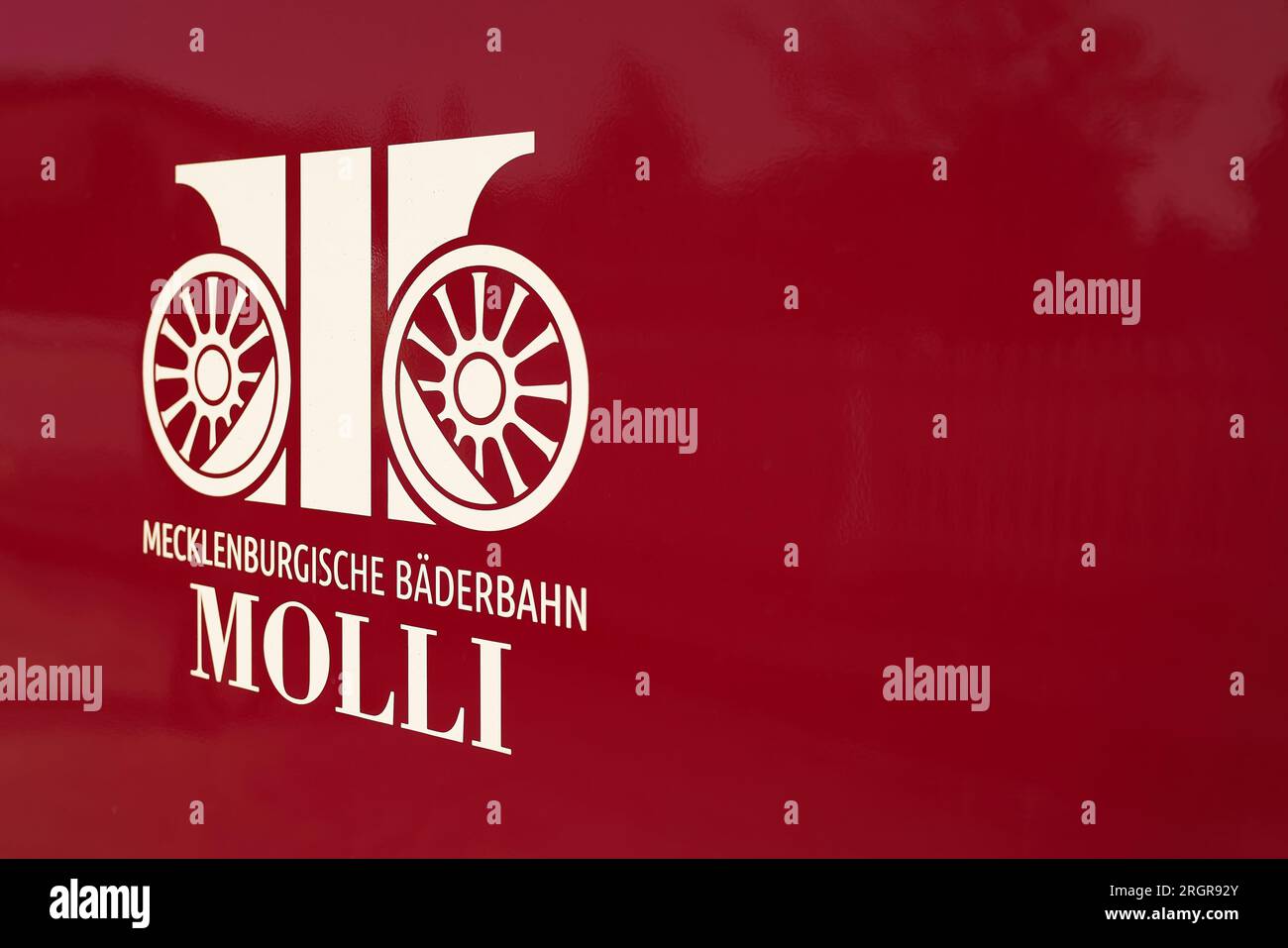 Symbol of Mecklenburgische Bäderbahn Molli GmbH on a wagon of the narrow-gauge railroad in Heiligendamm station in Germany with space for text Stock Photo