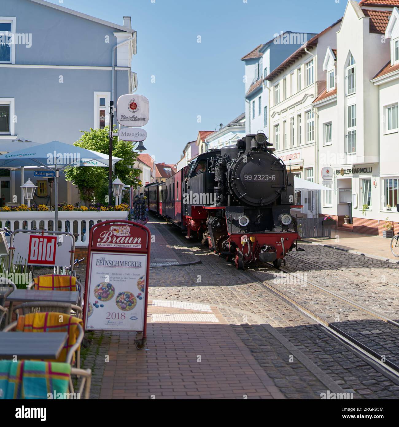 Passenger train of the tourist train Bäderbahn Molli during your journey through the old town of Bad Doberan at the German Baltic Sea Stock Photo