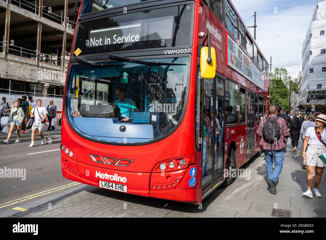 london-uk-11-august-2023-members-of-the-public-pass-a-double-decker