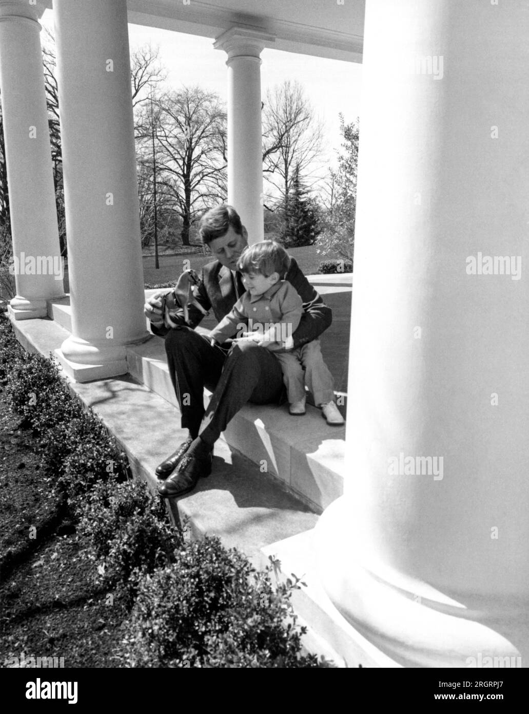 Washington,  D.C.:   c. 1962 President John F. Kennedy and son John-John play on the portals of the White House. Stock Photo