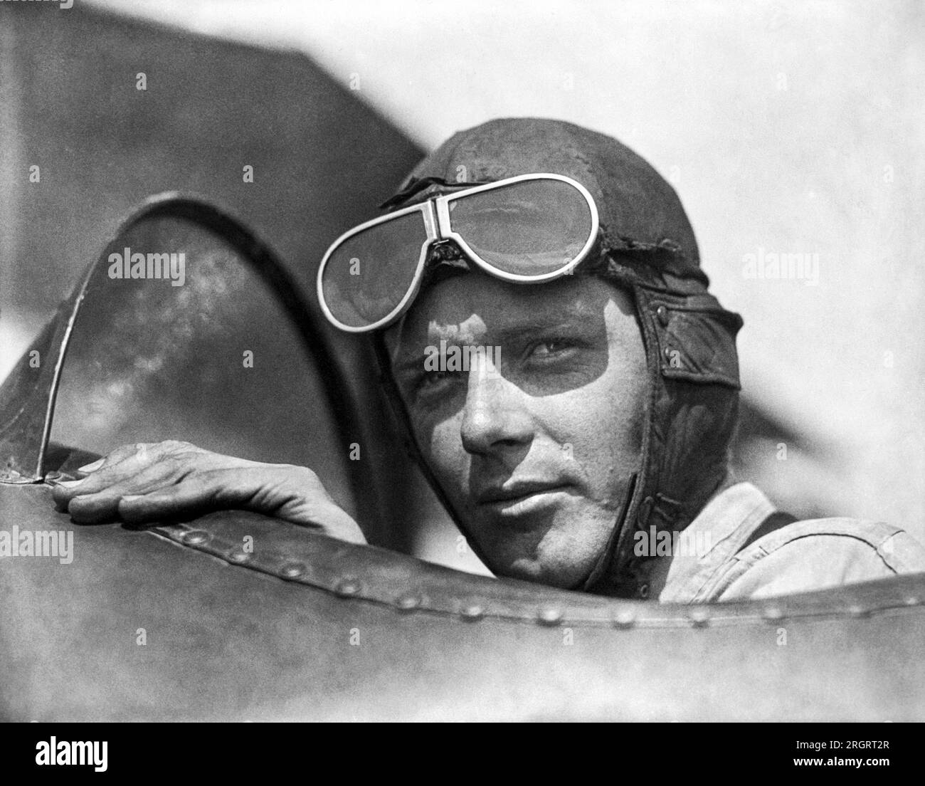 St. Louis, Missouri:  1923 Charles Lindbergh,wearing helmet with goggles up, in an open cockpit of an airplane at Lambert Field. Stock Photo