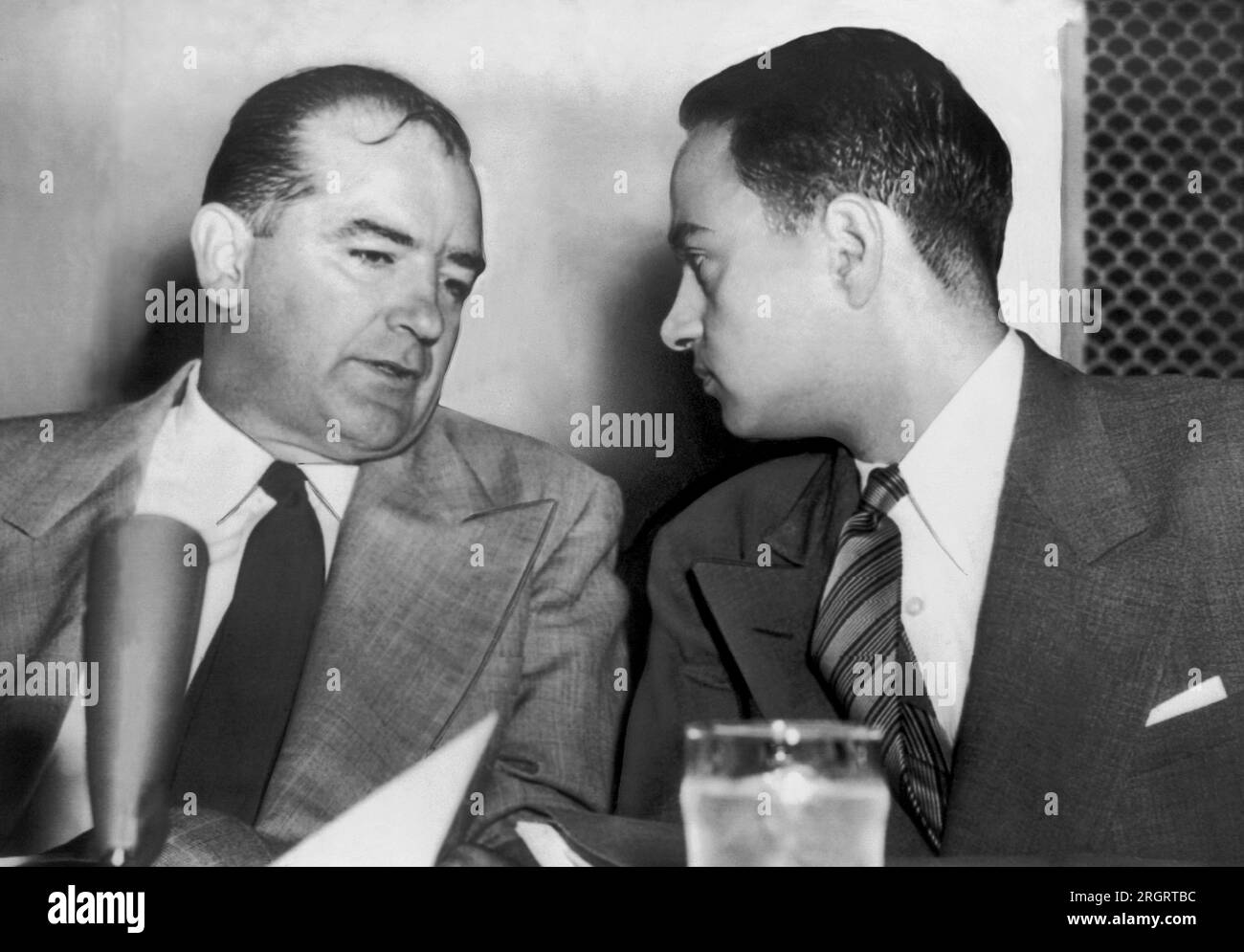 Washington, D.C.:  1954 Sen. Joseph McCarthy (l) chats with his attorney Roy Cohn (r) during Senate Subcommittee hearings on the McCarthy-Army dispute. Stock Photo