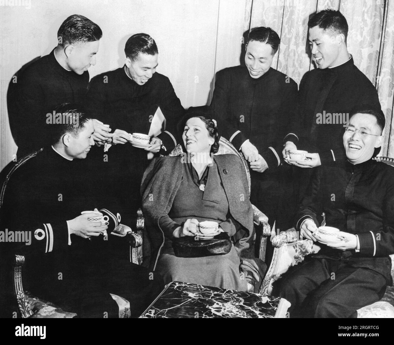 New York, New York:  March 7, 1944 Novelist Pearl Buck discusses the upcoming tribute to Dr. Sun Yat-Sen,  the "Father of China", with six Chinese Naval officers. The event will take place at the Metropolitan Opera House. Stock Photo