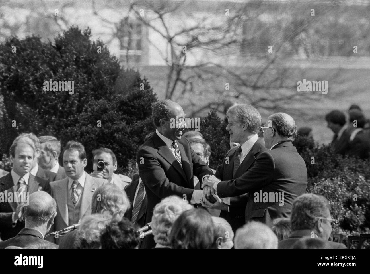 Washington, D.C.:  March 26, 1979 President Jimmy Carter shaking hands with Egyptian President Anwar Sadat and Israeli Prime Minister Menachem Begin at the signing of the Egyptian-Israeli Peace Treaty on the grounds of the White House. Stock Photo