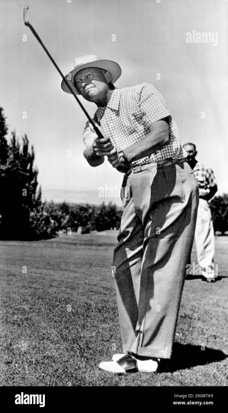 Englewood, Colorado:  August 13, 1953 President Eisenhower takes a practice swing with an eight iron as he warms up for a round of golf at Cherry Hills Country Club in Englewood, Colorado. Stock Photo