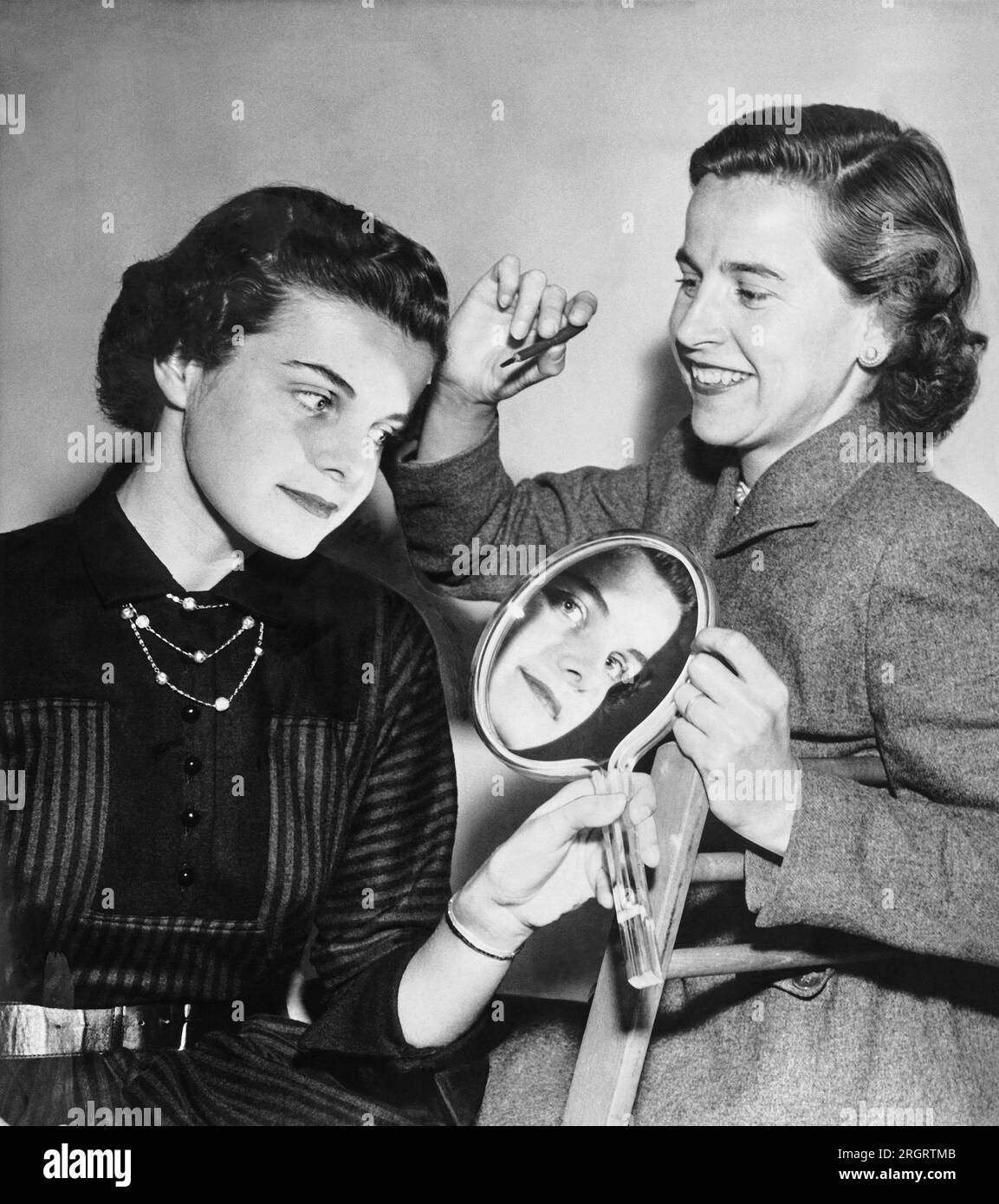 San Francisco, California:  October 24, 1955 Dianne Goldman gets her makeup touched up by Mrs. Frank HInman for a photo shoot as a doctor's model. Stock Photo
