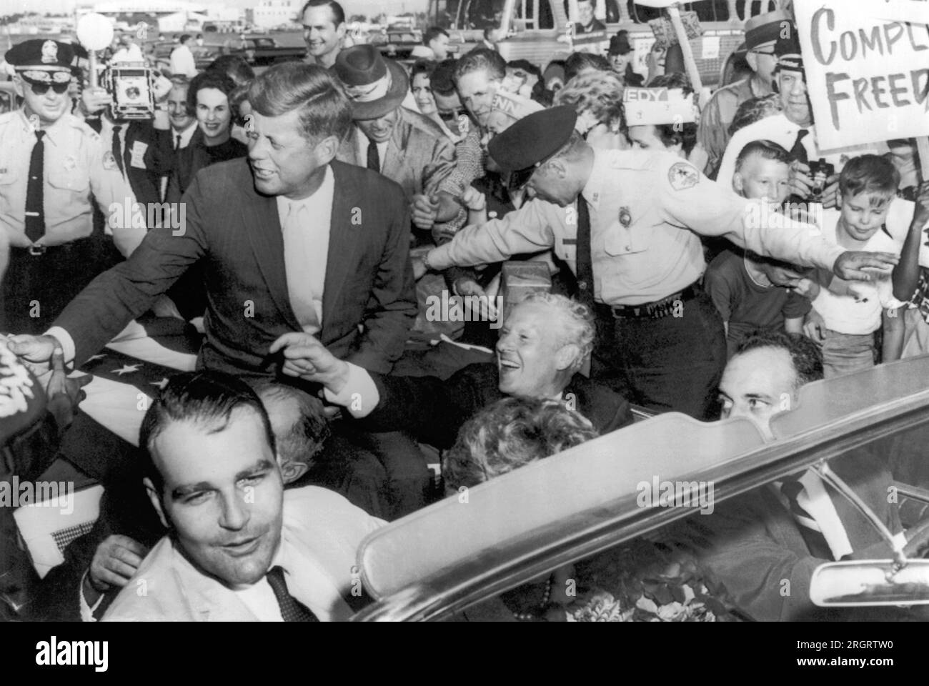 Memphis, Tennessee:  1960 Senator Kennedy is greeted in Memphis by supporters on his arrival at the airport. Senator Albert Gore is seated beside him and Memphis mayor Henry Loeb is at lower left. Stock Photo