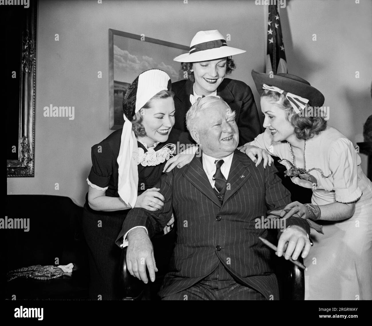 Washington, D.C.:  May 19, 1938 Vice President John Nance Garner was in fine fettle as he greeted visiting South Carolina azalea beauty queens. L-R: Elizabeth West, 1937 Azalea Queen; Margaret Lyon, 'Miss Charleston' of this year; and Dorothy Moore, Azalea Queen of 1938. Stock Photo