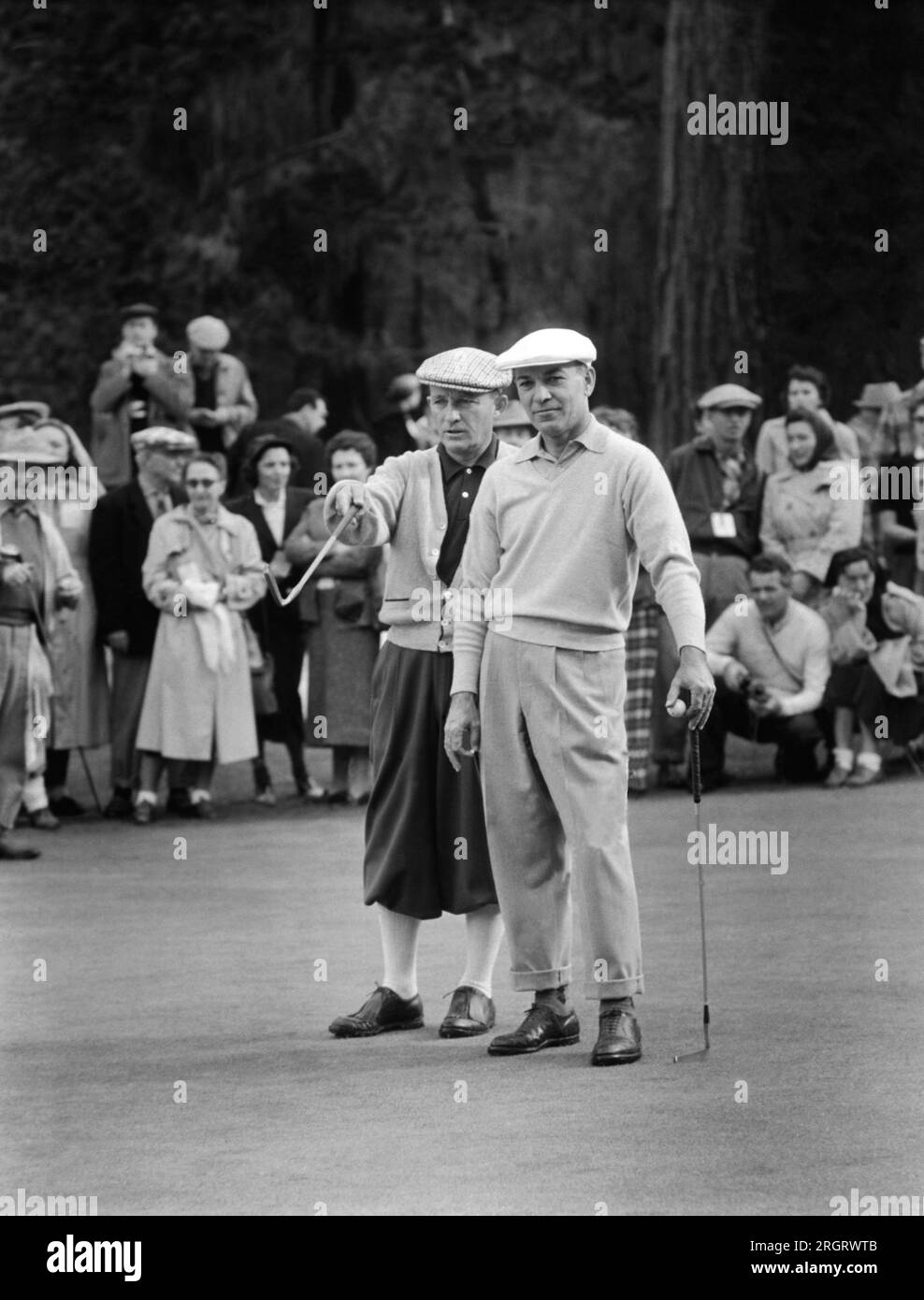 Pebble Beach, California:  c. 1948 Bing Crosby and Ben Hogan discuss golf. Stock Photo