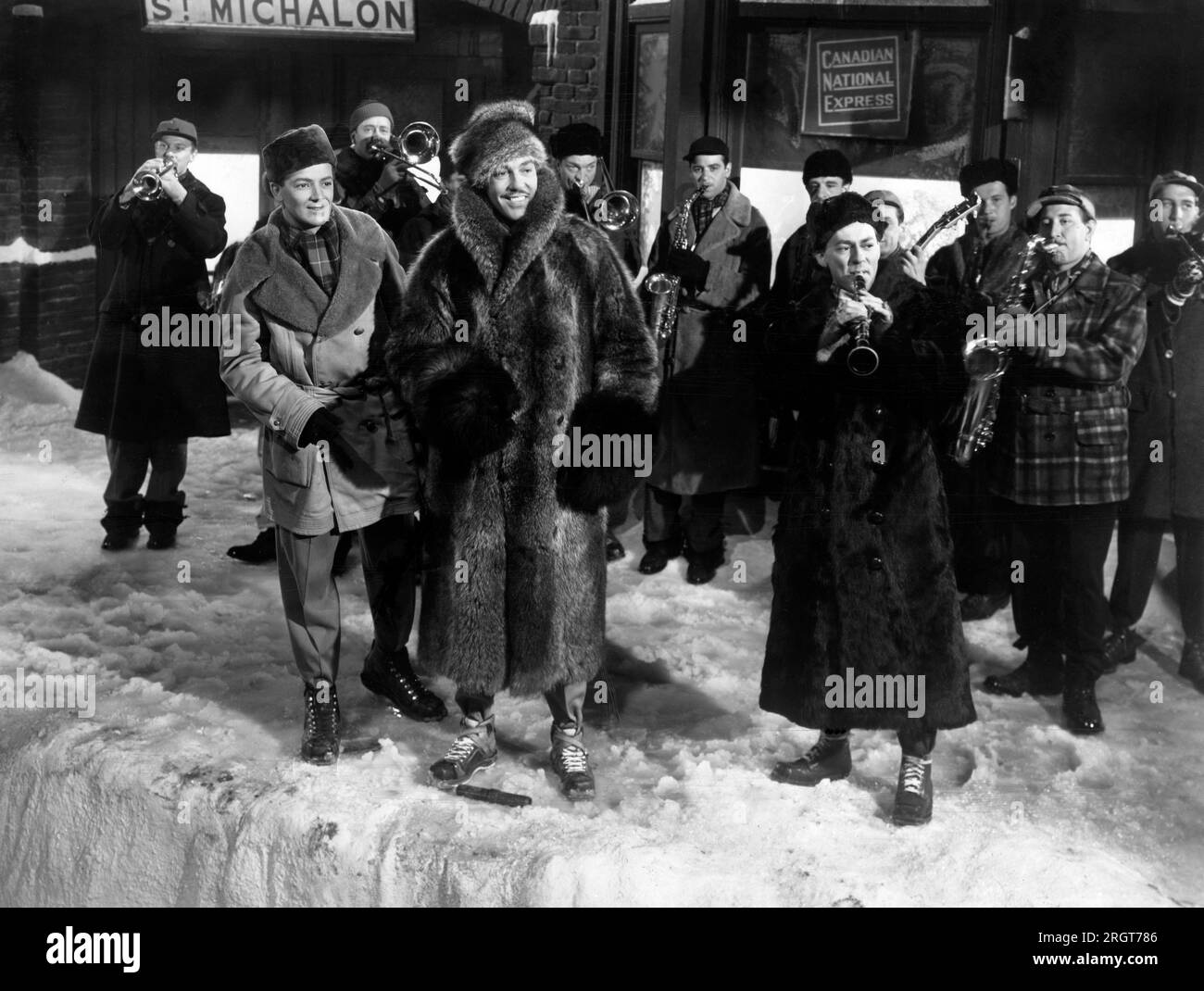 Cornel Wilde, Cesar Romero, Woody Herman (with clarinet), on-set of the Film, 'Wintertime', 20th Century-Fox, 1943 Stock Photo
