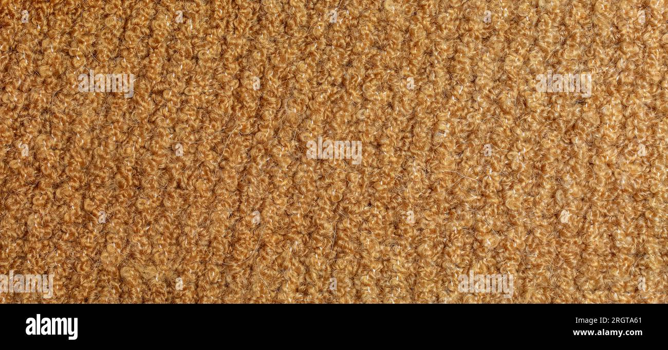 Knitted wool textile with background texture in light beige creamy brown shade. Beige color gradient on texture background. Scarf. Stock Photo