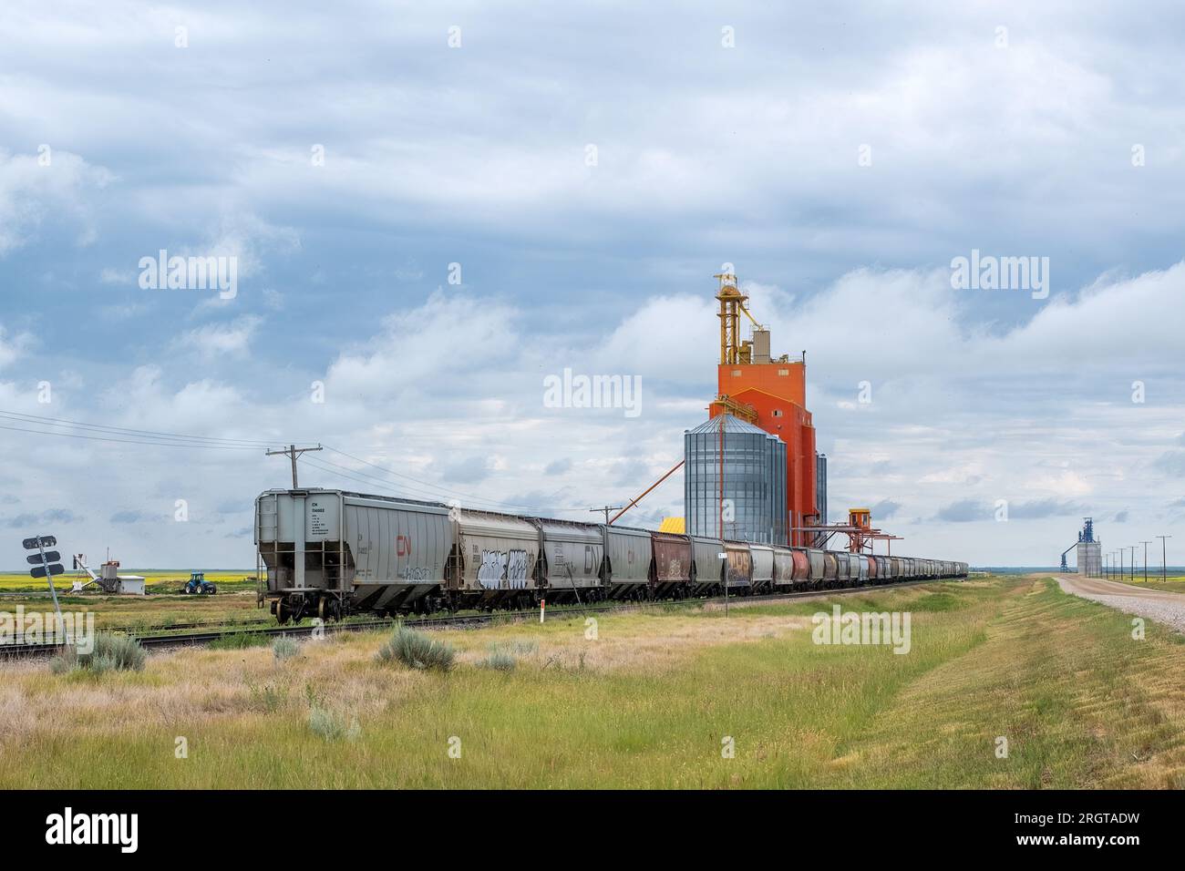 Rail cars parked on a siding next to a grain elevator in rural Sakatchewan. Stock Photo