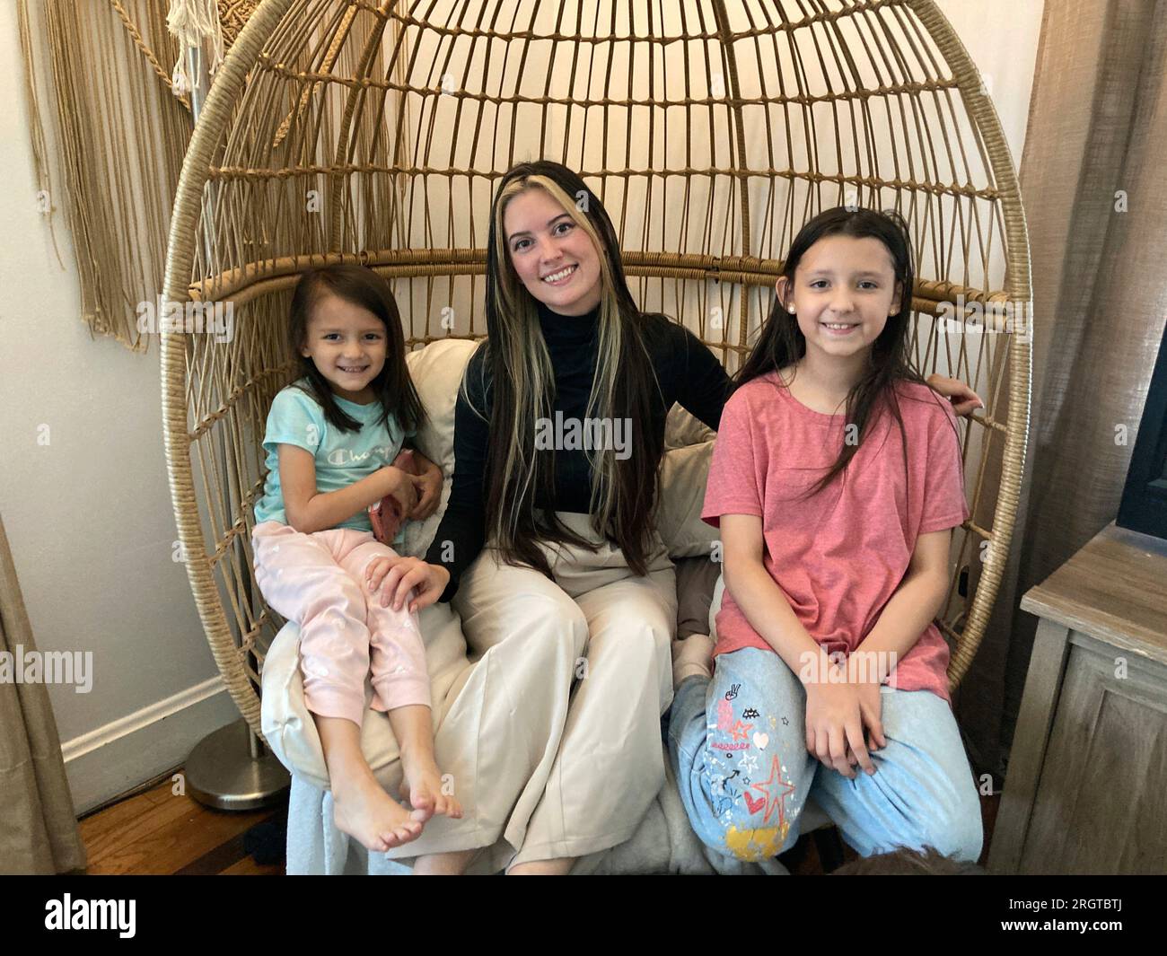 Parent Berkley Collins sits with her two elementary school children, Emma,  right, and Arai, in Louisville, Ky., Friday, Aug. 11, 2023. Collins said  her daughter Emma was two hours late being dropped