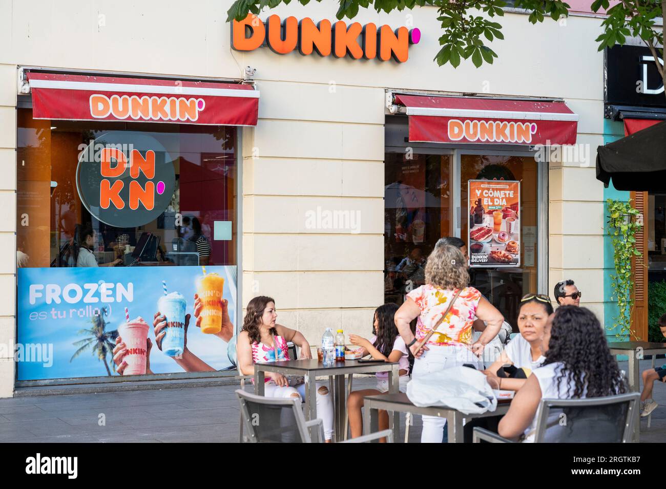 Customers are seen eating at the American multinational coffee and snack  chain Dunkin' Donuts in Spain Stock Photo - Alamy