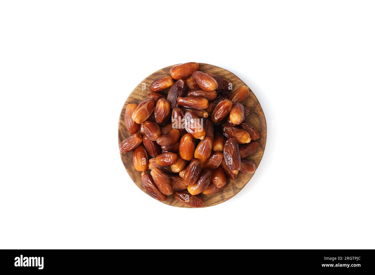 Dates in a wooden plate isolated on a white background. Dried fruits ...