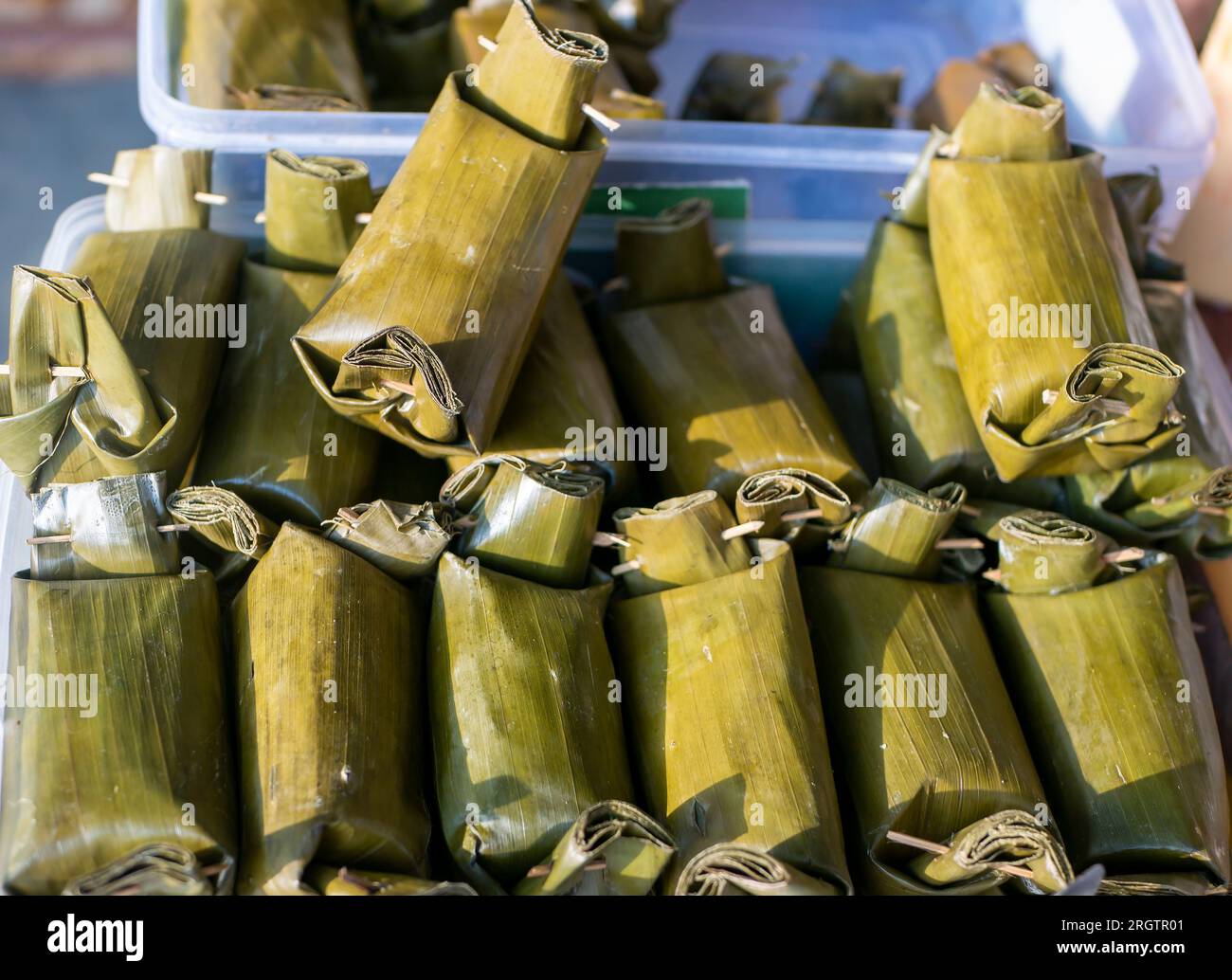 Lemper, Indonesian traditional snack, made from sticky rice and wrapped in banana leaves. Stock Photo