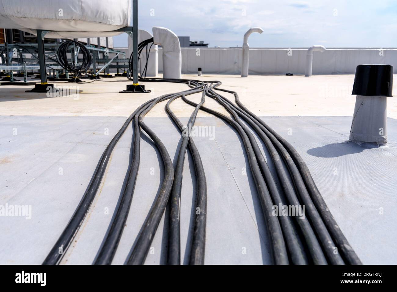 Laying cables and wires on the roof of an industrial building Stock