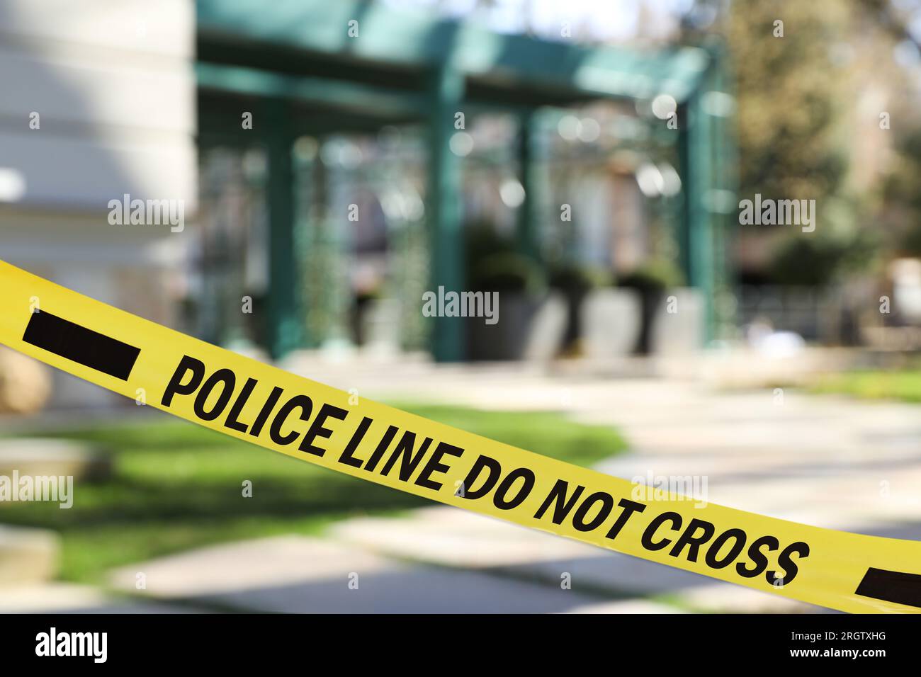 Yellow crime scene tape blocking way on street Stock Photo Alamy
