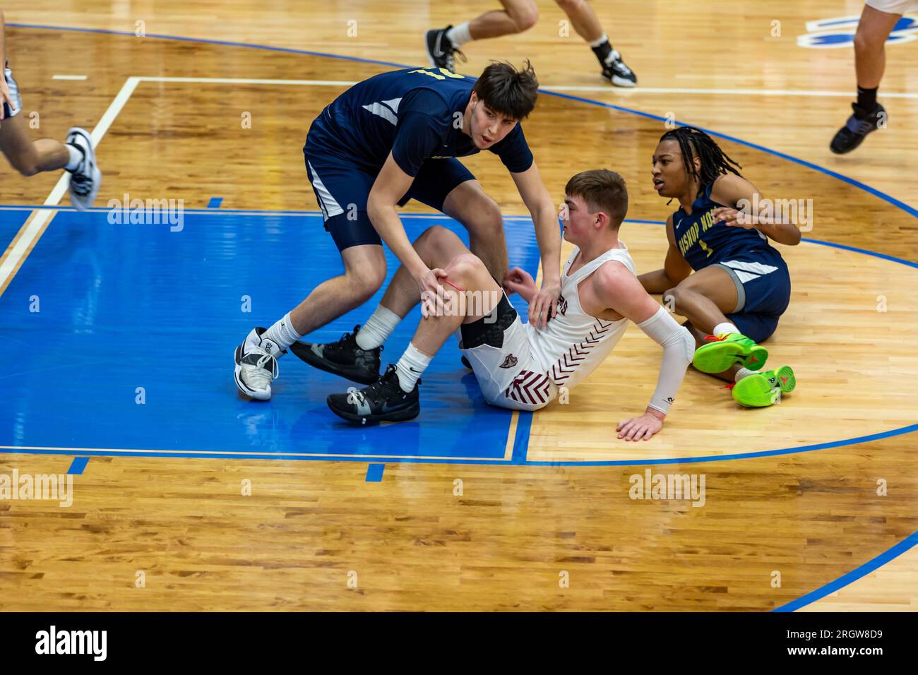Conner Essegian is on the floor after a play in a high school basketball game between Central Noble and Hammond Noll at North Judson, Indiana, USA. Stock Photo
