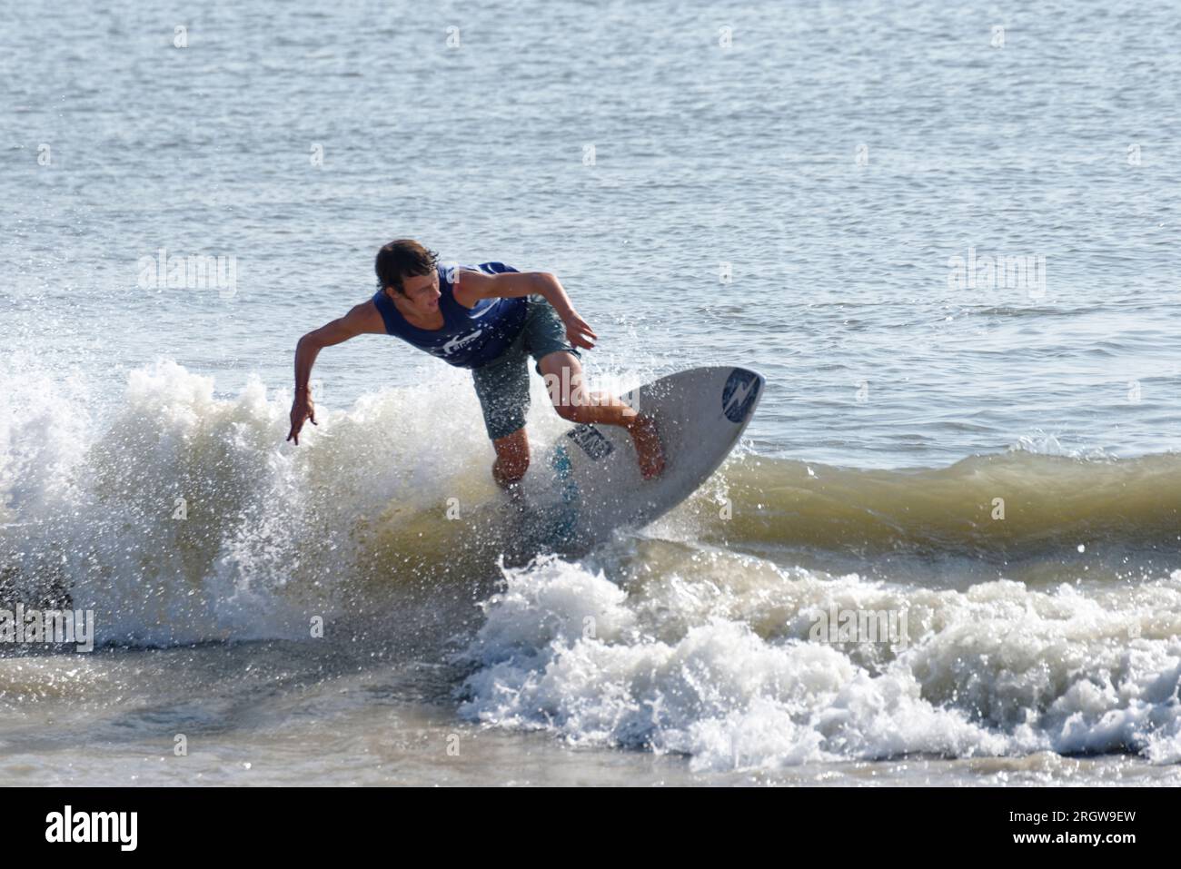 Contestant rides for points during heat at the Zap Pro/Am Championships of Skimboarding, August 11, 2023, Dewey Beach, Delaware USA. Stock Photo