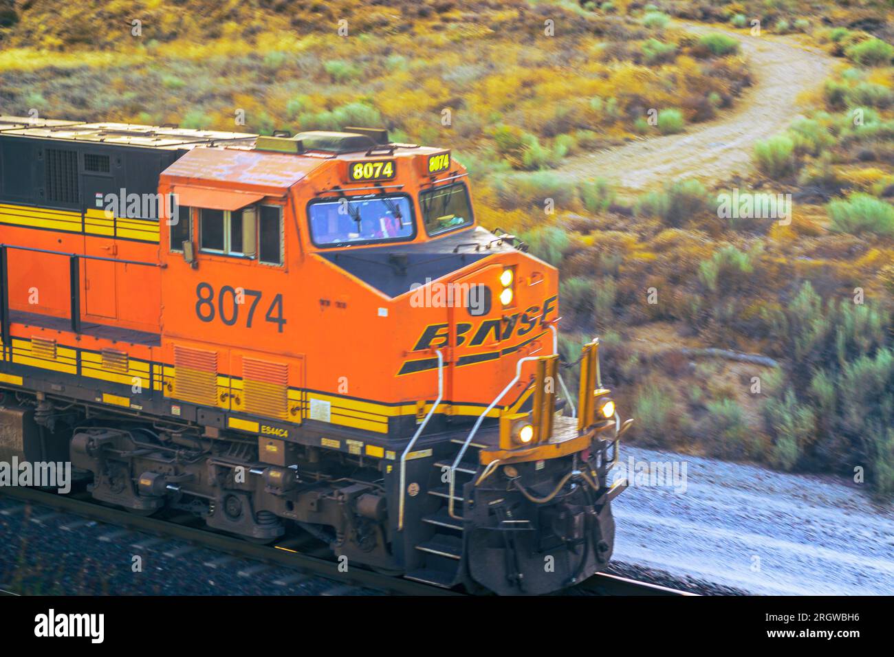 Immerse yourself in the detailed close-up view of BNSF 8074 east as it travels up BNSF Main Track #1 at Hill 582 in the Cajon Pass. Stock Photo