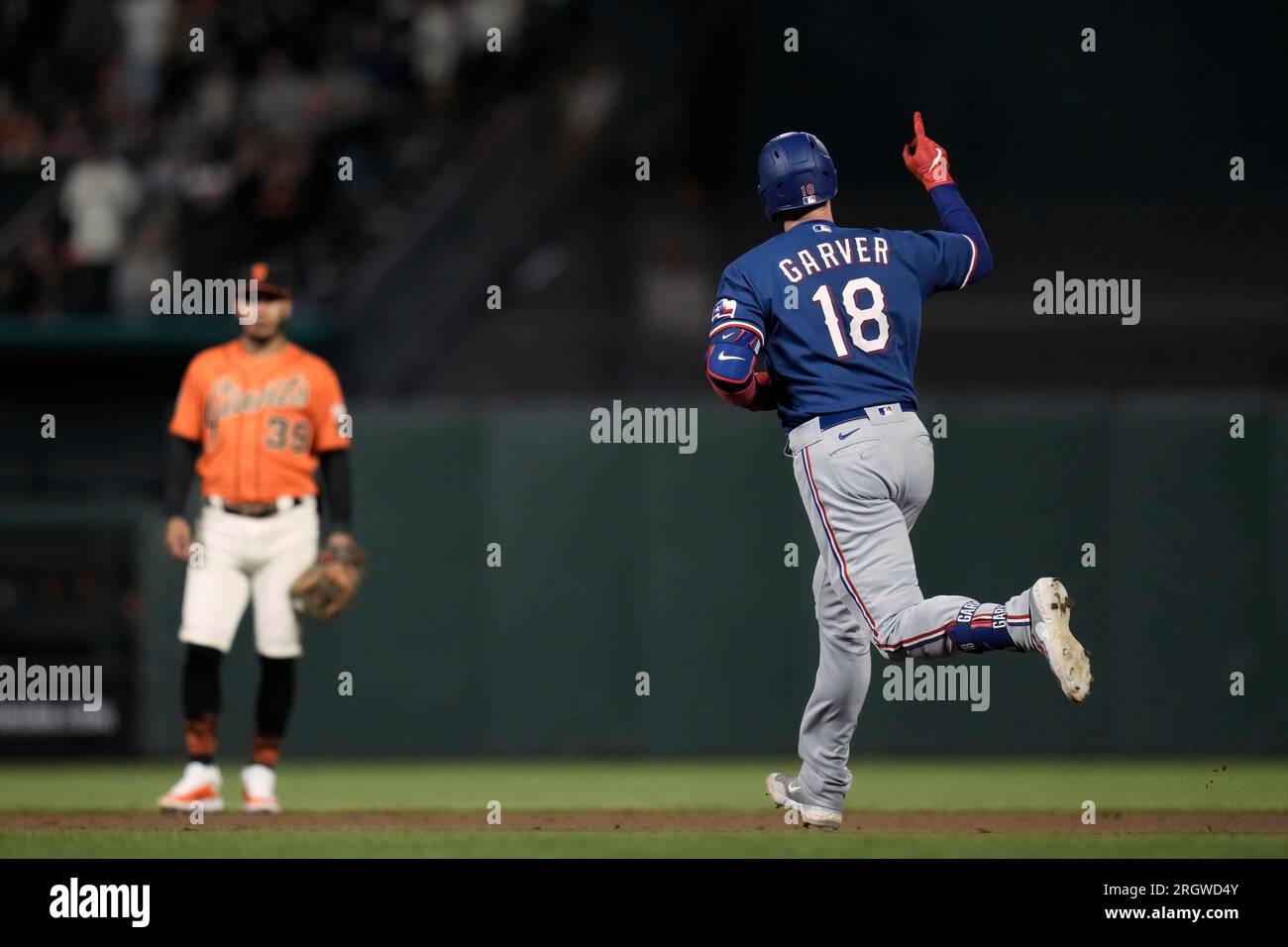 Texas Rangers' Mitch Garver, right, high-fives Travis Jankowski after Garver hit a home run against the Minnesota Twins during the second inning of a baseball game Friday, Aug. 25, 2023, in Minneapolis. (