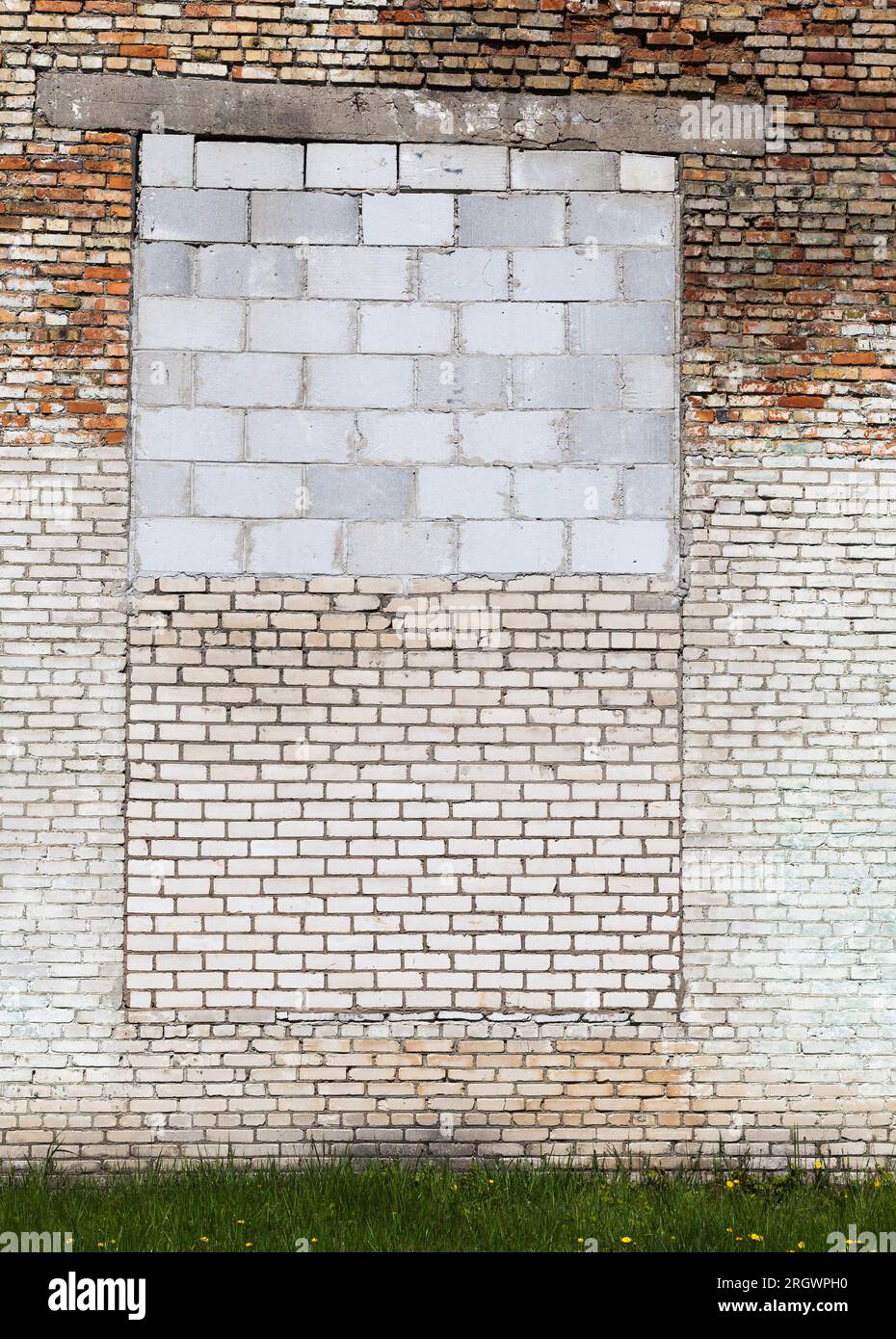 the wall of the building is made of different quality and types of bricks and blocks, mixed