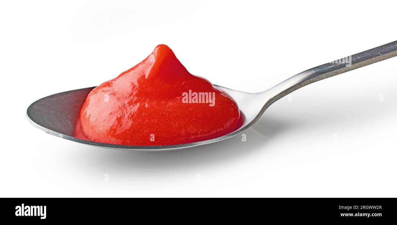 tomato ketchup puree in a spoon isolated on white background Stock