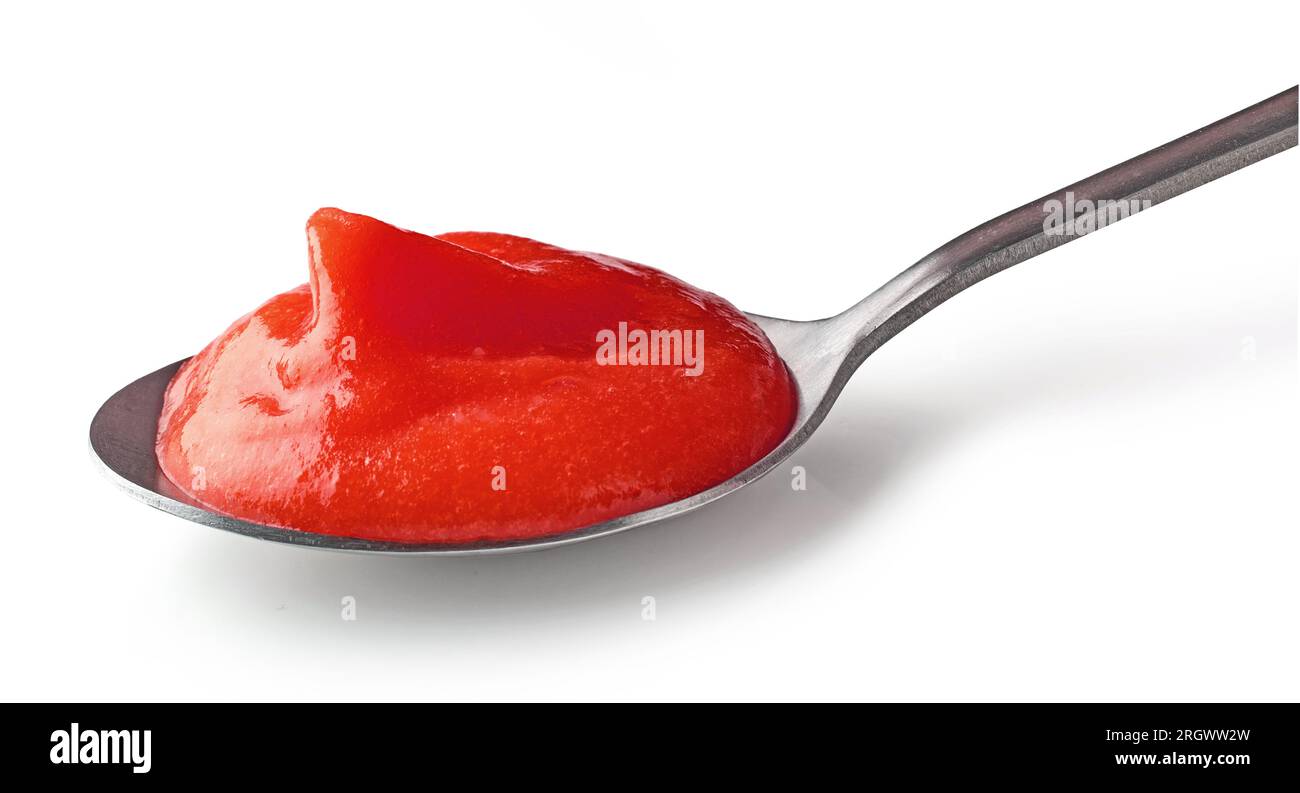 tomato ketchup puree in a spoon isolated on white background Stock