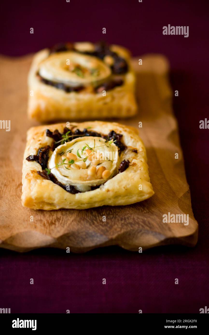 Small tarts with red onion ,goat cheese,pine nut and thyme Stock Photo