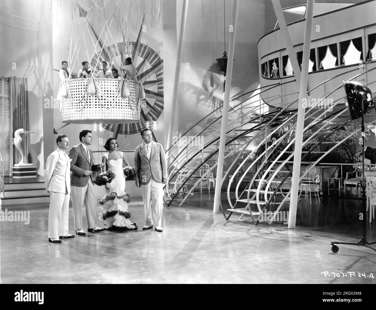 Head of Art Department VAN NEST POLGLASE Associate Producer LOU BROCK DOLORES DEL RIO and Unit Art Director CARROLL CLARK on set candid viewing the Dirigible nightclub set during filming of FLYING DOWN TO RIO 1933 director THORNTON FREELAND music Vincent Youmans lyrics Gus Kahn and Edward Eliscu costumes Walter Plunkett and (uncredited) Irene RKO Radio Pictures Stock Photo