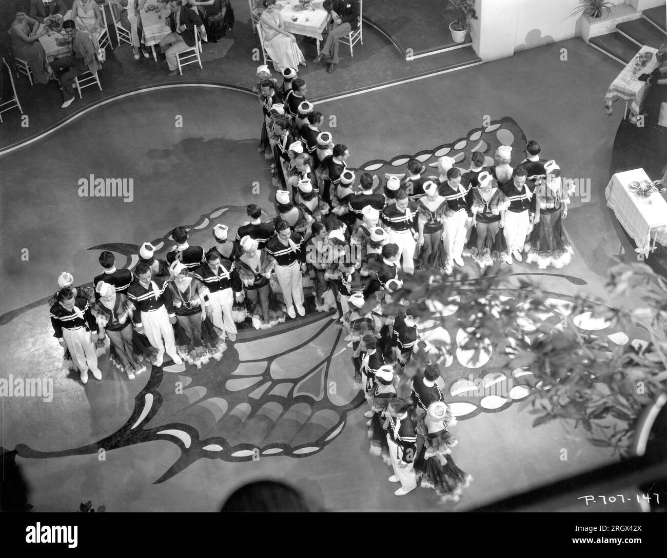 Male and Female Dancers forming shape of plane in nightclub musical number in FLYING DOWN TO RIO 1933 director THORNTON FREELAND music Vincent Youmans lyrics Gus Kahn and Edward Eliscu costumes Walter Plunkett and (uncredited) Irene RKO Radio Pictures Stock Photo