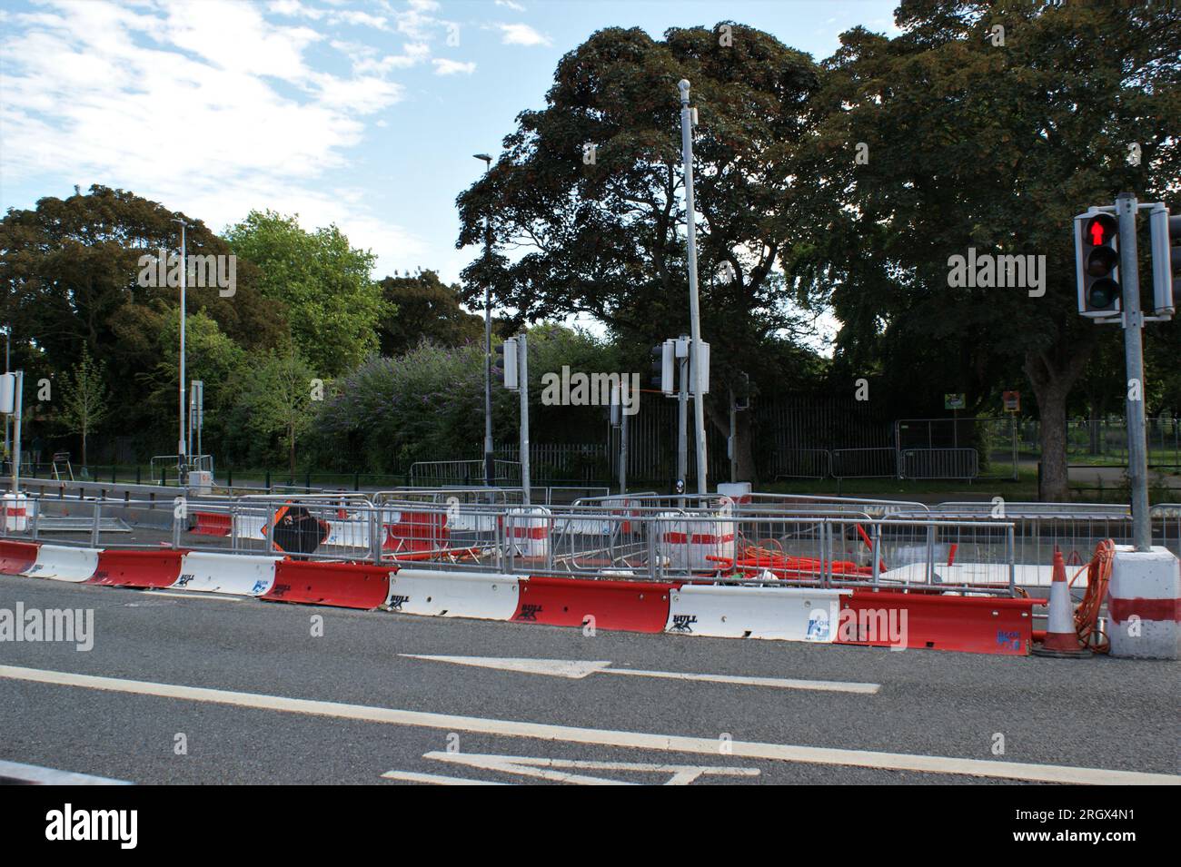 Road repair site in the city. Barrier fences and traffic lights
