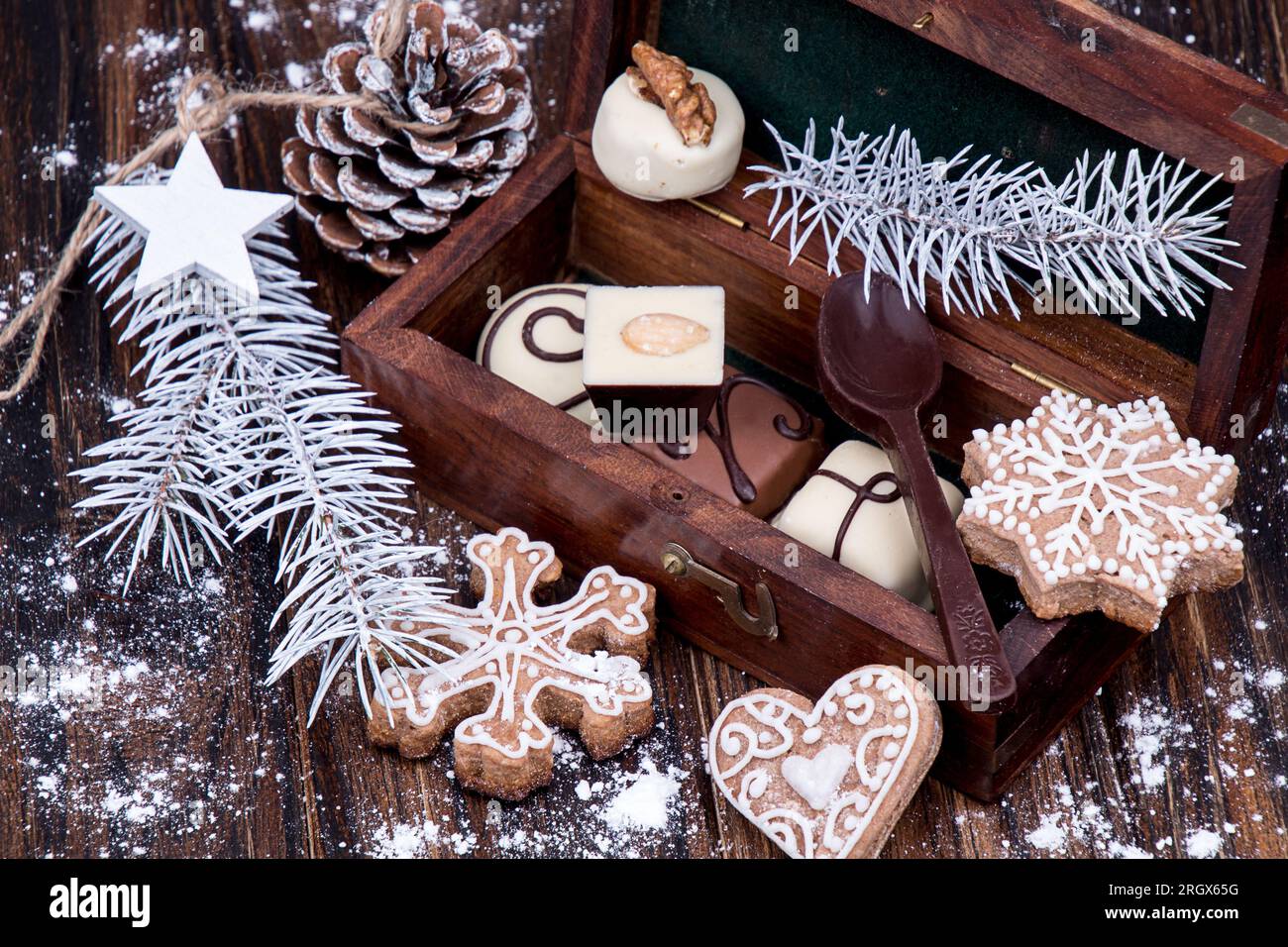 Christmas food still life of gingerbread cookies and chocolate candies in wooden gift box. Christmas New Year decoration. Stock Photo