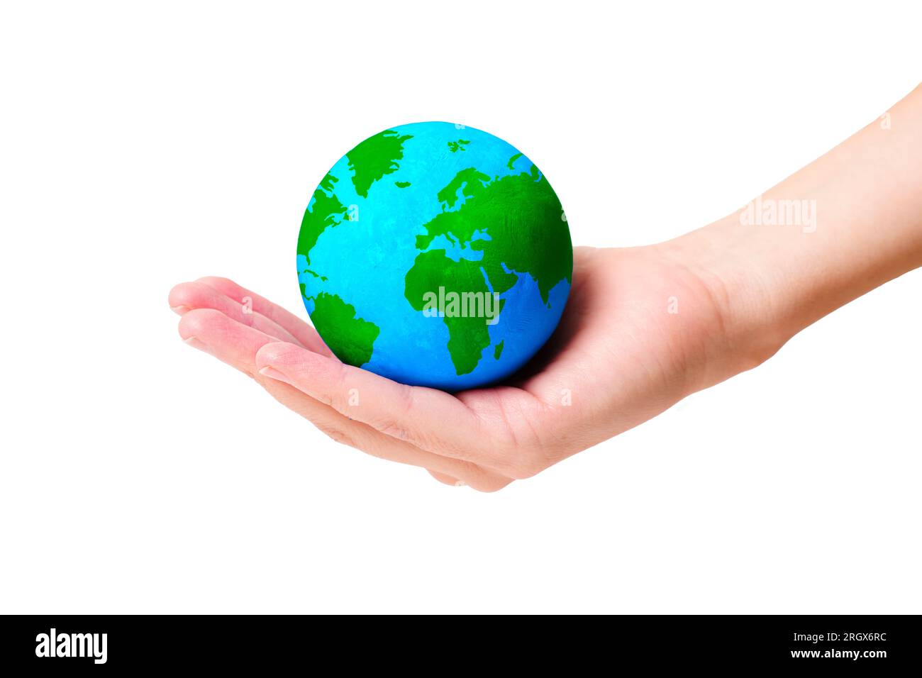 Hand gently cradles a globe model with vibrant green continents ...