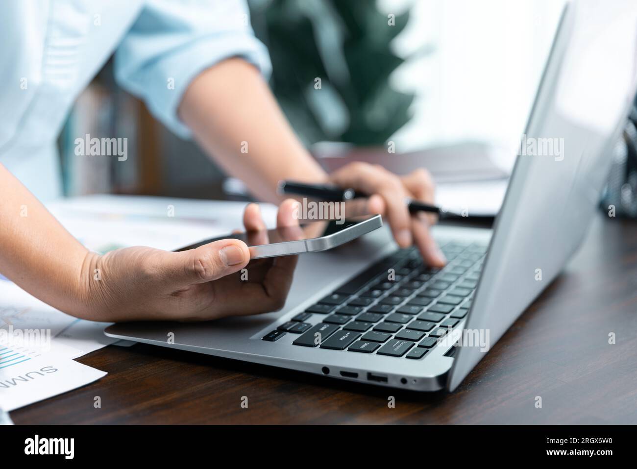 Businesswomen working to analyze, work together to discuss company financial statistics, brainstorm ideas, and graph documents on the table. Stock Photo