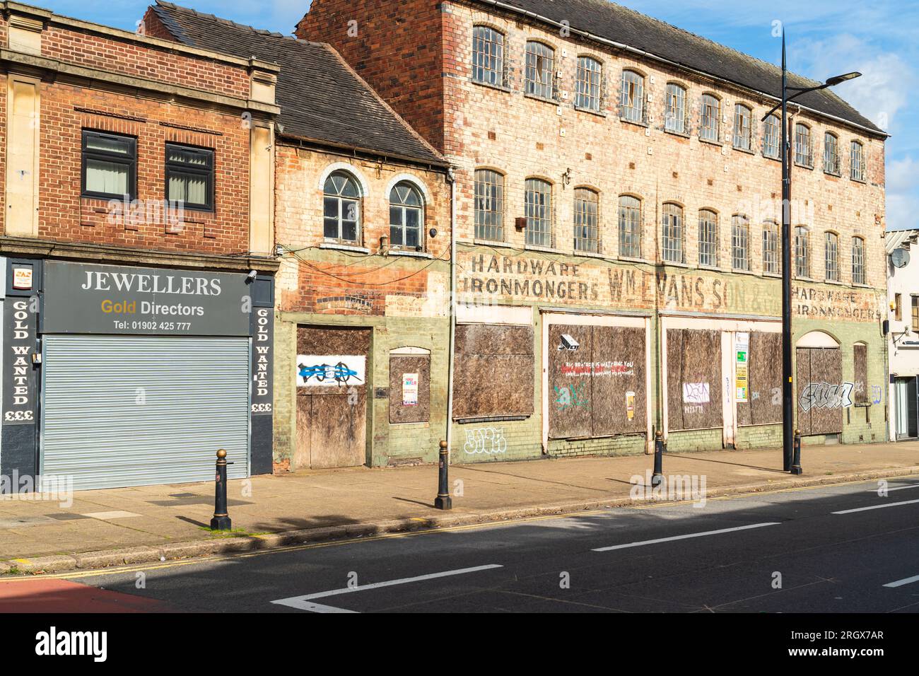 Wolverhampton, UK - August 11 2023: Row of shuttered shops in Wolverhampton, UK.  Concept of businesses closing, to rent, to let Stock Photo