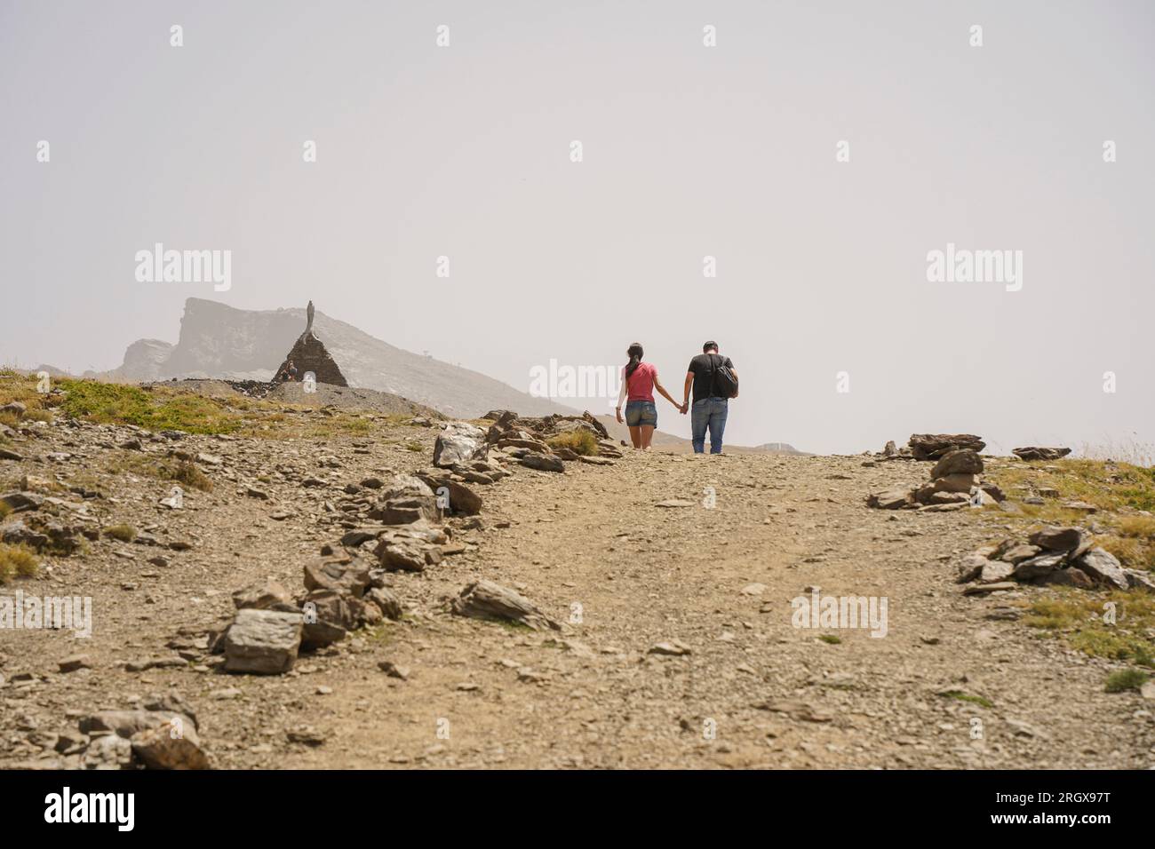 Couple walking around Hoyo de la Mora, Sierra Nevada, in summer season. Granada, Andalusia, Spain. Stock Photo