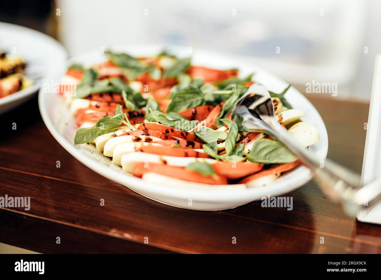 Tomato and mozzarella with basil leaves Stock Photo - Alamy