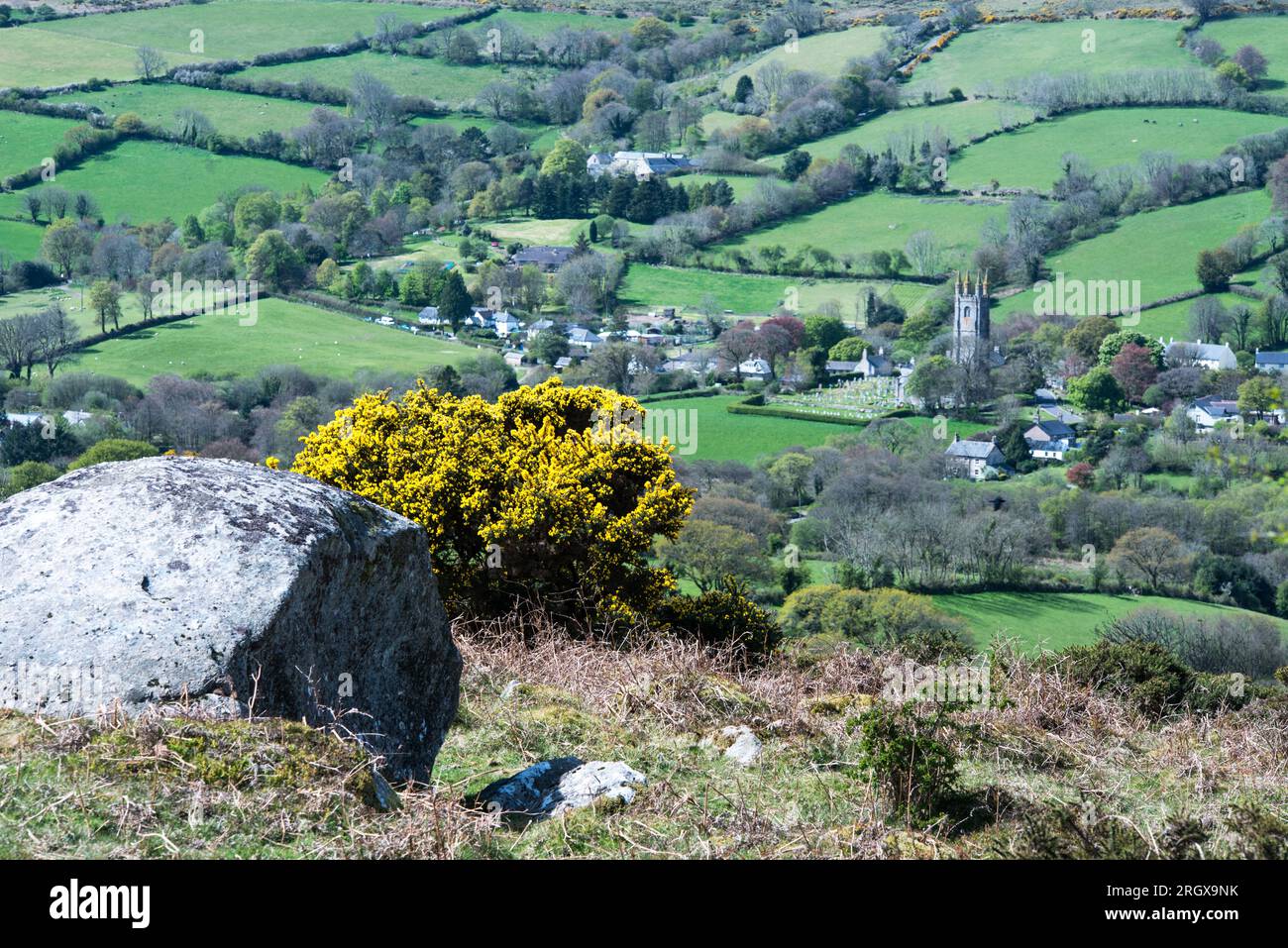 Looking down on the well known village of Widecombe in the Moor from Bonehill Rocks on Dartmoor on a sunny April day. Stock Photo