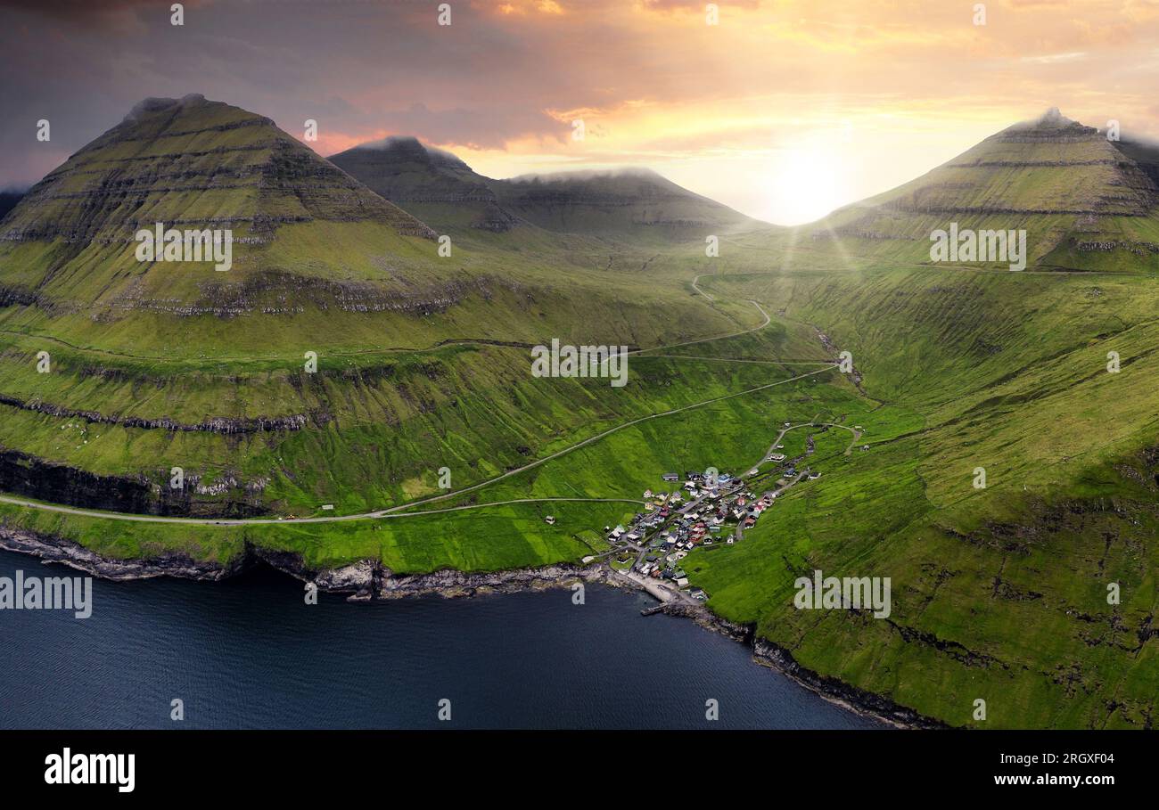 Sunset Aerial panorama of mountains and ocean around village of Funningur on Faroe Islands, Denmark landscape Stock Photo